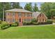 Stately brick residence showcasing lush landscaping and a welcoming front entrance at 5545 Durrett Dr, Atlanta, GA 30338