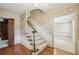Inviting foyer with hardwood floors, staircase, and classic wallpaper, leading to other rooms at 5545 Durrett Dr, Atlanta, GA 30338