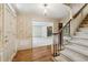 Elegant foyer showcasing hardwood floors, a staircase, and decorative wallpaper accents at 5545 Durrett Dr, Atlanta, GA 30338