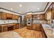 Gourmet kitchen featuring wood cabinets, granite countertops, stainless steel appliances, and hardwood floors at 5545 Durrett Dr, Atlanta, GA 30338