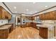 Gourmet kitchen featuring wood cabinets, granite countertops, stainless steel appliances, and hardwood floors at 5545 Durrett Dr, Atlanta, GA 30338