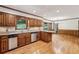 Spacious kitchen boasts wood cabinets, granite countertops, stainless steel appliances and hardwood floors at 5545 Durrett Dr, Atlanta, GA 30338