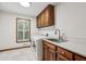 The laundry room features front loading washer and dryer, sink and storage cabinet at 5545 Durrett Dr, Atlanta, GA 30338