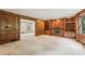 Spacious living room features wood paneling, fireplace, and custom built-in bookshelves at 5545 Durrett Dr, Atlanta, GA 30338