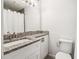 Bathroom featuring granite counters, white cabinets, and a shower with curtain at 1931 Brian Way, Decatur, GA 30033
