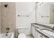 Bathroom featuring granite counters, white cabinets, tiled walls and shower/tub combo at 1931 Brian Way, Decatur, GA 30033