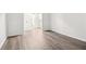 Open bedroom leading to the bathroom with grey wood-look flooring at 1931 Brian Way, Decatur, GA 30033