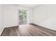 Bedroom features a sliding glass door and grey wood-look flooring at 1931 Brian Way, Decatur, GA 30033