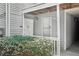 Exterior entryway featuring covered porch with white door, trim, and partial shrubbery at 1931 Brian Way, Decatur, GA 30033