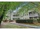 Apartment complex with landscaped walkway, trimmed hedges, white railings, and multiple floors at 1931 Brian Way, Decatur, GA 30033