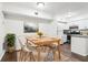 Dining area with wood table, seating for four, and view of the kitchen at 1931 Brian Way, Decatur, GA 30033