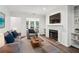 Bright living room with hardwood floors, a fireplace, tv, and neutral toned furniture at 1931 Brian Way, Decatur, GA 30033