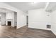 Open-concept living room features a fireplace and grey wood flooring at 1931 Brian Way, Decatur, GA 30033