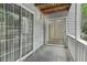 Enclosed patio with two sliding doors to interior and view of surrounding landscape at 1931 Brian Way, Decatur, GA 30033