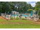 Outdoor pool area surrounded by green landscaping and a protective fence at 1931 Brian Way, Decatur, GA 30033
