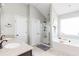 Bright bathroom featuring double sinks, a separate shower, and a soaking tub near a window at 327 Nobleman Way, Canton, GA 30114