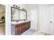 Bathroom featuring double sinks, a large mirror, and ample lighting at 327 Nobleman Way, Canton, GA 30114