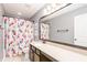 Bathroom featuring a long vanity, a patterned shower curtain, and ample lighting at 327 Nobleman Way, Canton, GA 30114