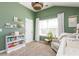 A Bedroom with a bookshelf, large window, crib, accent chair and neutral color carpet at 327 Nobleman Way, Canton, GA 30114