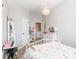 Bright bedroom featuring a bed, chandelier, walk-in closet, and a playful design at 327 Nobleman Way, Canton, GA 30114