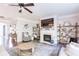 Stylish living room featuring a fireplace, open shelving, and comfortable furnishings at 327 Nobleman Way, Canton, GA 30114