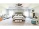 Large main bedroom with neutral colors, a ceiling fan, and plenty of natural light at 327 Nobleman Way, Canton, GA 30114