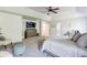 Spacious bedroom featuring plush carpeting, a ceiling fan, a TV, and neutral decor at 327 Nobleman Way, Canton, GA 30114
