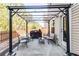 Backyard patio features a pergola with hanging lights and a grill at 327 Nobleman Way, Canton, GA 30114
