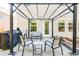 View of the backyard patio with a pergola, grill, and seating area at 327 Nobleman Way, Canton, GA 30114