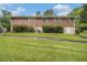 Property with a spacious backyard, mature landscaping, and a sturdy brick home at 4125 Lindsey Dr, Decatur, GA 30035