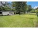 Expansive backyard featuring green grass, trees, and a shed at 4125 Lindsey Dr, Decatur, GA 30035