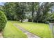 Large backyard with a shed, mature trees, and expansive green lawn at 4125 Lindsey Dr, Decatur, GA 30035