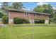 Brick home with a large, lush green lawn and mature trees at 4125 Lindsey Dr, Decatur, GA 30035