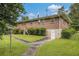 Spacious backyard with lush grass, mature trees, and a well-maintained brick home at 4125 Lindsey Dr, Decatur, GA 30035