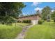 Backyard view of a well-maintained brick home with a manicured lawn and mature trees at 4125 Lindsey Dr, Decatur, GA 30035