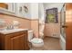 Bathroom with peach-toned tile, matching accents, a sink, toilet, and shower/tub combo at 4125 Lindsey Dr, Decatur, GA 30035