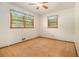 Bedroom featuring neutral carpet, two windows with curtains, and a ceiling fan at 4125 Lindsey Dr, Decatur, GA 30035