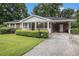 Attractive brick home with a well-kept lawn, carport, and welcoming entrance at 4125 Lindsey Dr, Decatur, GA 30035