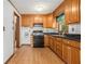 Classic kitchen featuring wooden cabinets, black appliances and countertops, with wood-look floors at 4125 Lindsey Dr, Decatur, GA 30035