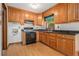 Classic kitchen with wooden cabinetry, black countertops and appliances, plus a window at 4125 Lindsey Dr, Decatur, GA 30035