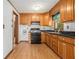 Traditional kitchen featuring oak cabinets, black countertops, and stainless steel appliances at 4125 Lindsey Dr, Decatur, GA 30035