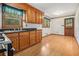 Kitchen boasts wooden cabinets, black countertops and appliances, and a wood-look floor at 4125 Lindsey Dr, Decatur, GA 30035
