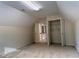 Carpeted attic space with closets and doorway at 636 Lantern Park Ln, Scottdale, GA 30079