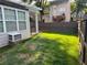 Private fenced backyard with lush green grass and mature trees offers a serene outdoor space at 636 Lantern Park Ln, Scottdale, GA 30079