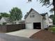 View of the backyard showing a two-car garage, fenced-in yard, and landscaped details at 636 Lantern Park Ln, Scottdale, GA 30079