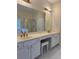 Bathroom featuring double sinks, gold fixtures, and separate tub/shower at 636 Lantern Park Ln, Scottdale, GA 30079