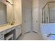 Bathroom featuring white cabinets and countertop, gold hardware, and separate shower at 636 Lantern Park Ln, Scottdale, GA 30079