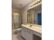 Bathroom featuring white cabinets and countertop, gold hardware, and shower/bath combo at 636 Lantern Park Ln, Scottdale, GA 30079