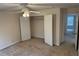 Cozy bedroom with standard closet, neutral carpet, and ceiling fan with light fixture at 636 Lantern Park Ln, Scottdale, GA 30079