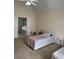 Cozy bedroom featuring vaulted ceiling, twin beds, and a view of an ensuite bath at 636 Lantern Park Ln, Scottdale, GA 30079
